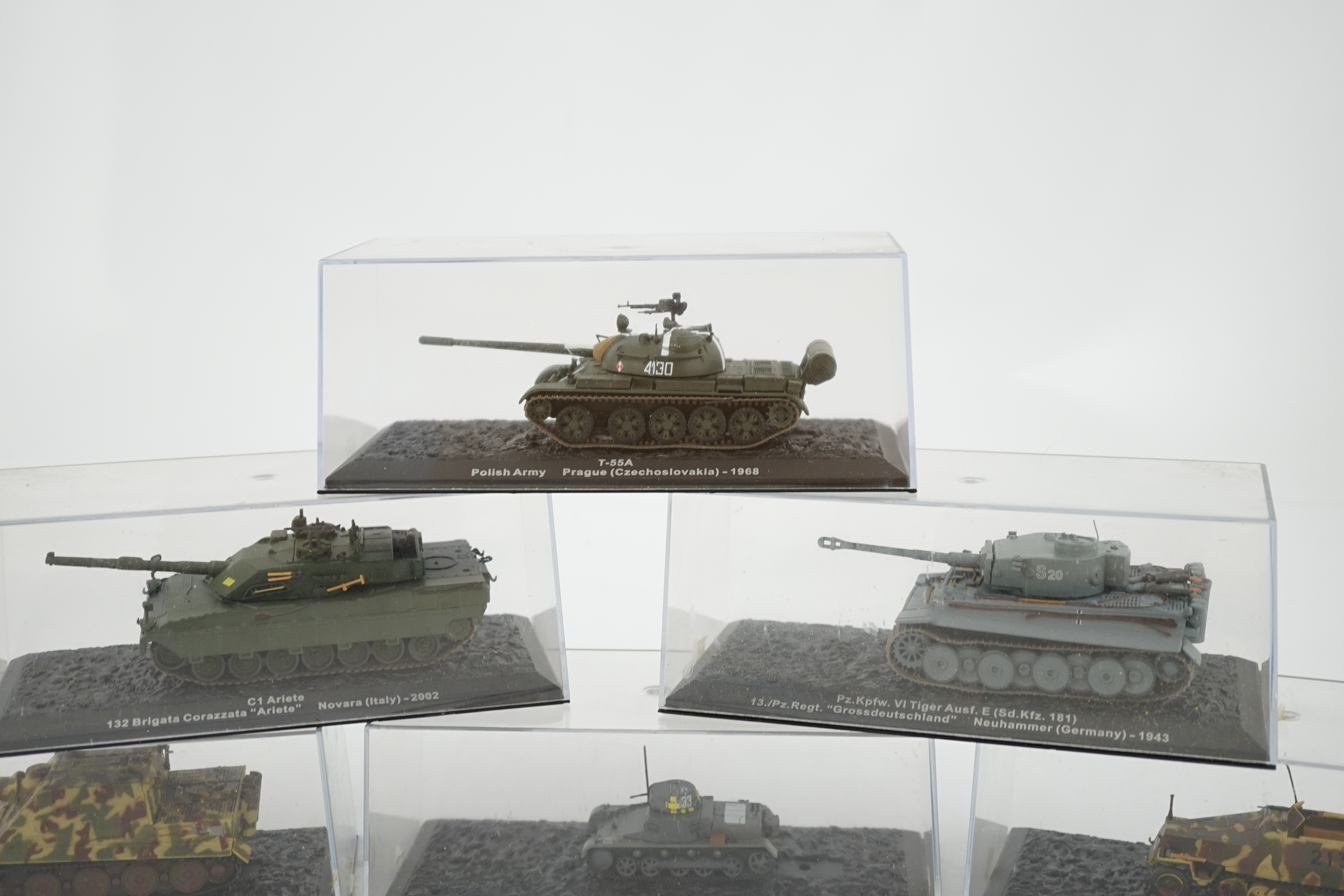 Sixty-eight magazine issue military vehicles in plastic display cases, including; tanks, armoured cars, personnel transporters, etc.